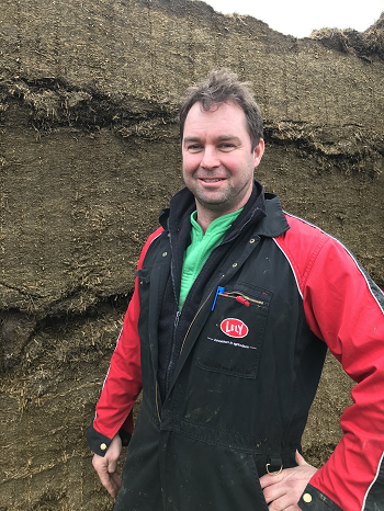 Andrew Dale in front of the lucerne silage